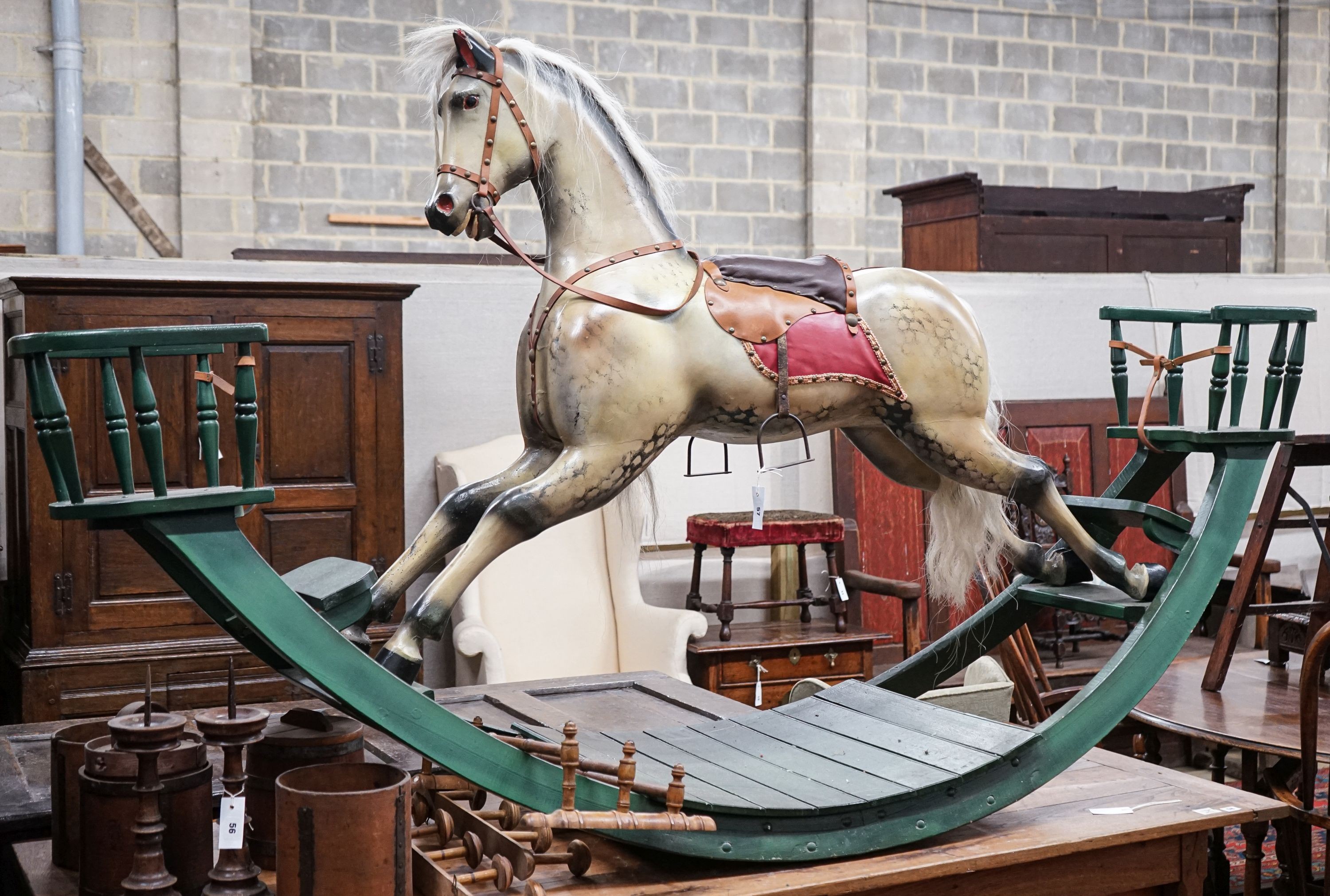 A large Victorian style painted rocking horse with end seats, length 240cm, height 132cm